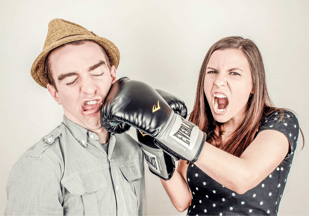woman hitting a man with boxing glove