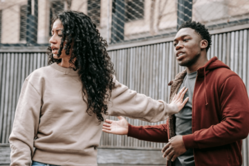 woman pushing man away with her hand