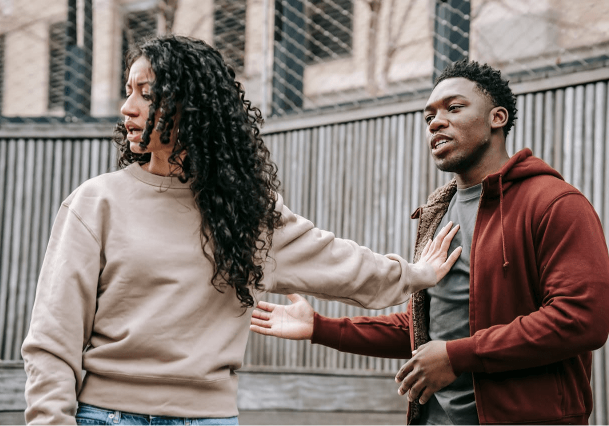 woman pushing man away with her hand