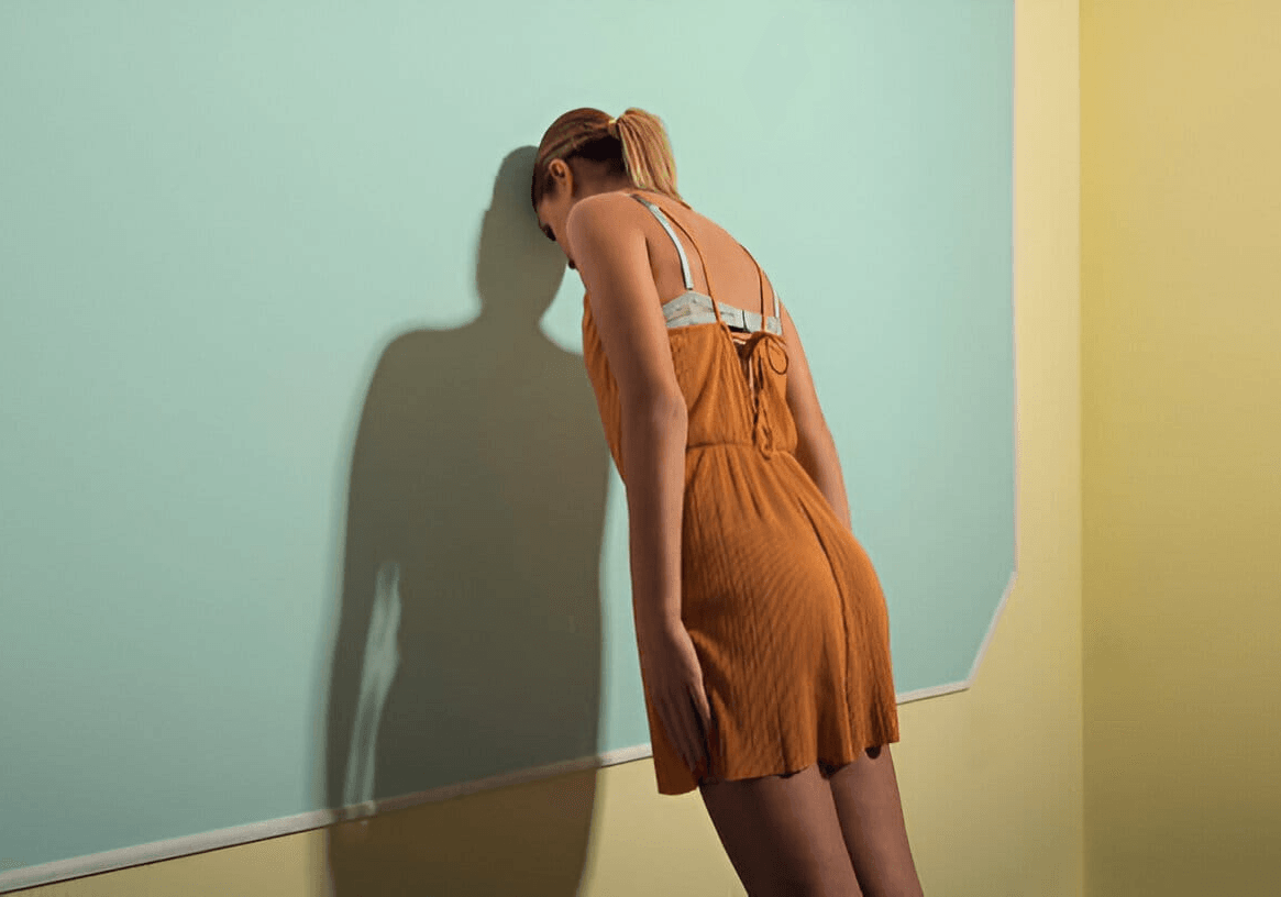 woman wailing against the wall