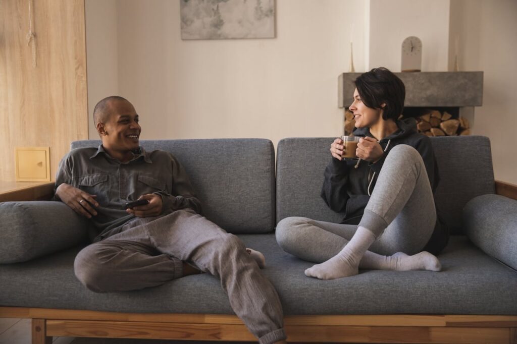 happy couple talking on the sofa