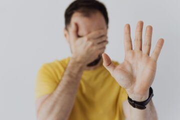 a man with hand extended stop