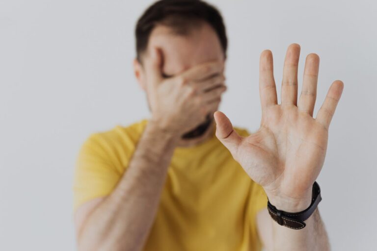 a man with hand extended stop