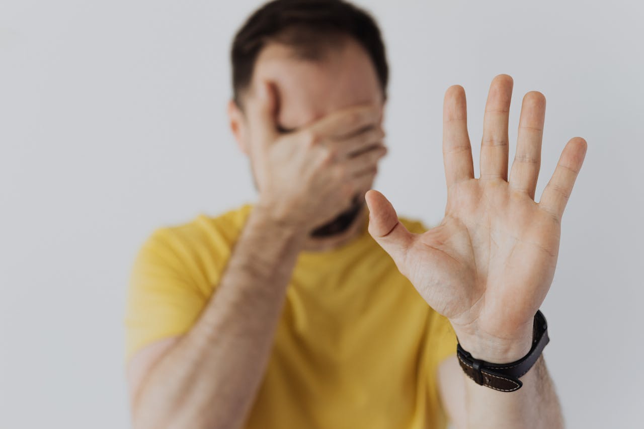 a man with hand extended stop